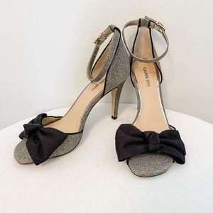 Gianni Bini metallic ankle strap heel with black bow accent. Size 8.